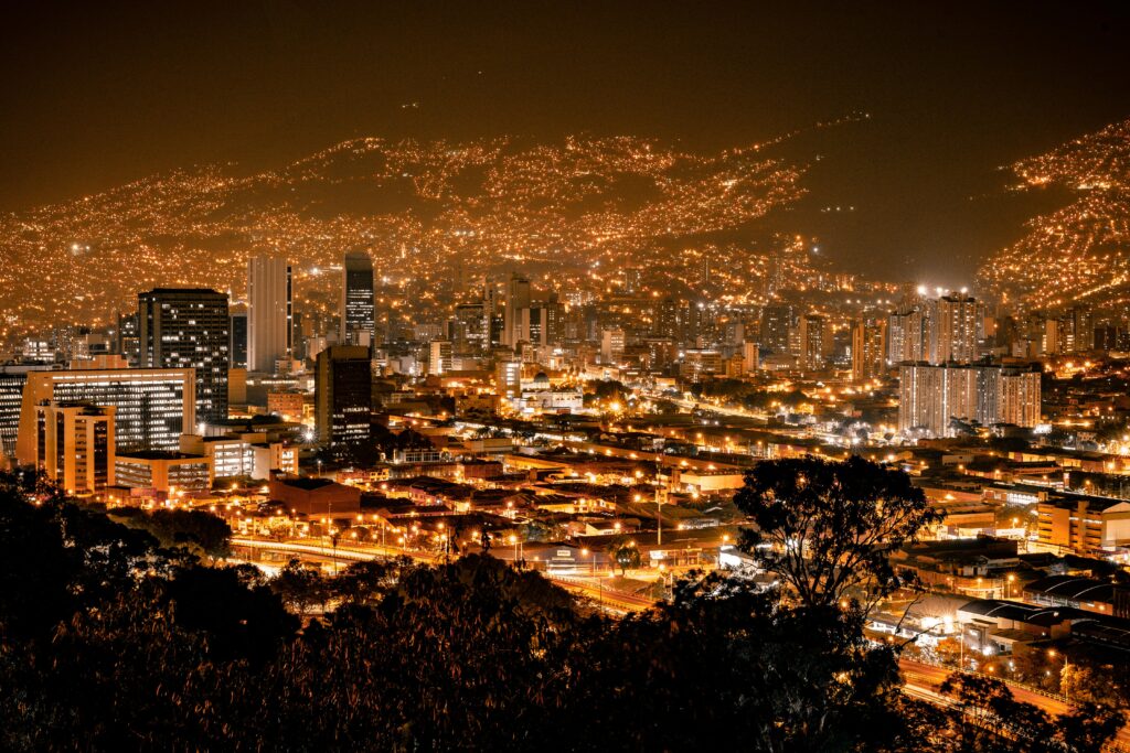 Explore the vibrant cityscape of Medellín, Colombia, illuminated at night.